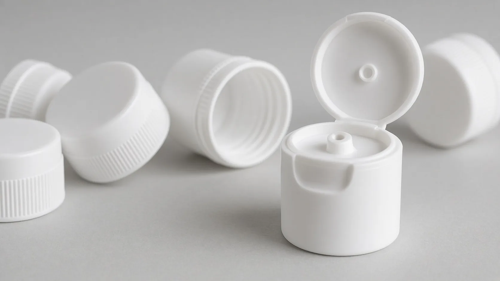 White disc top caps on a bench, one disc flipped open
